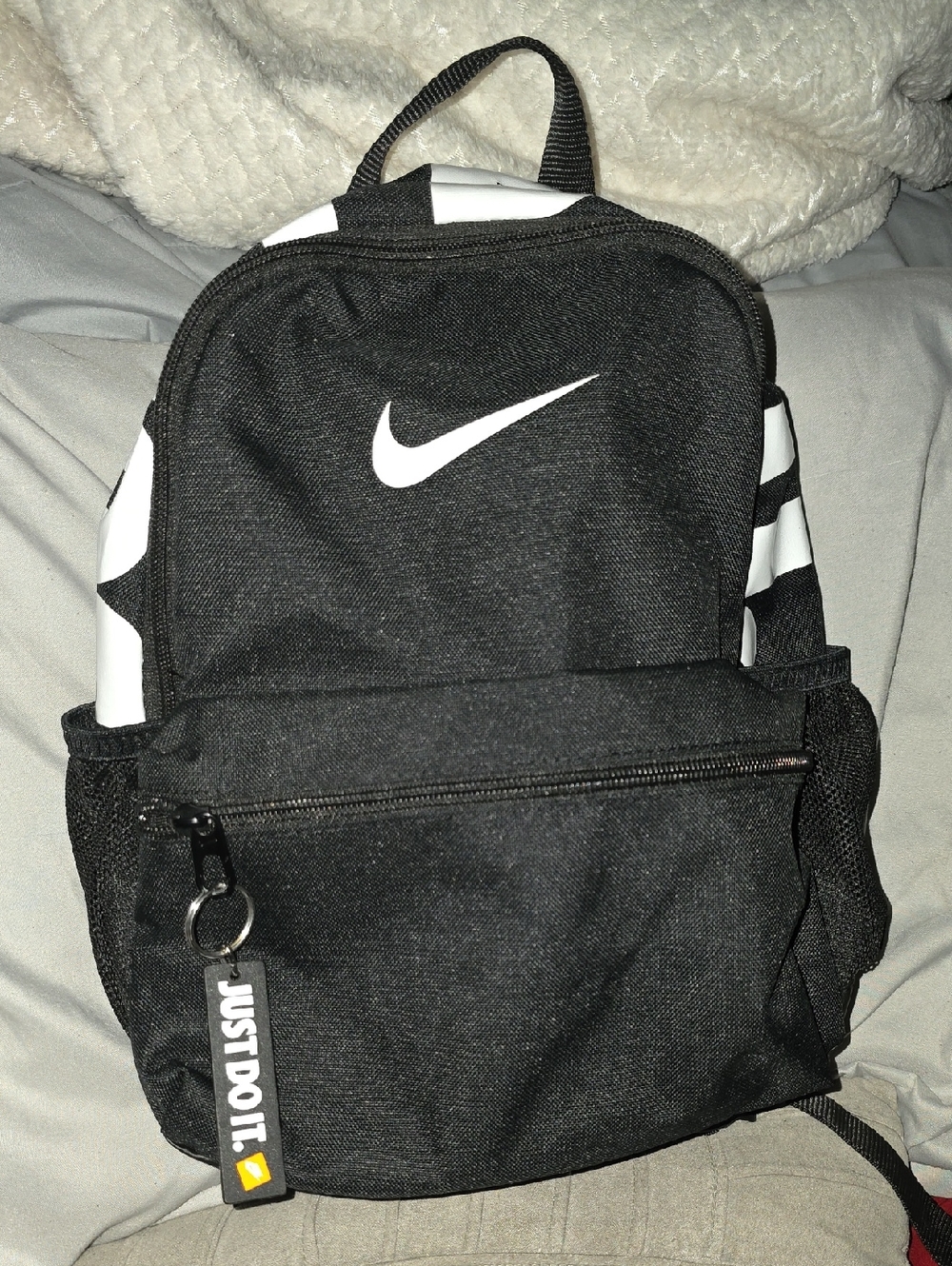 Nike Black Backpack with White Swoosh and Striped Accents